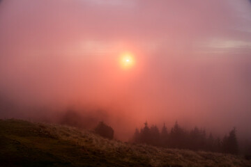 Sunrise in the fog, Ceahlau Mountains, Romania 