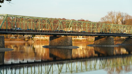 One old rion frames bridge view on the river with the sunset sky as background