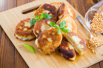 cooked fried pea pies on a wooden board