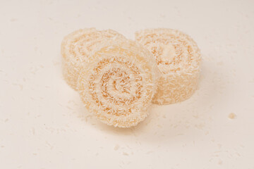 Coconut candy roll isolated on a white background.