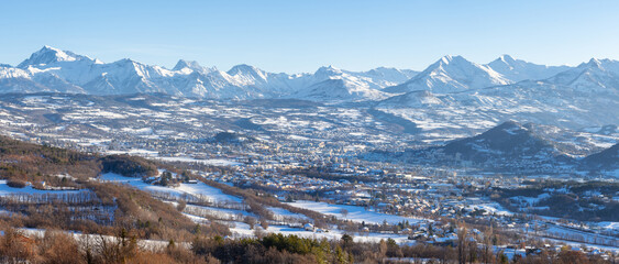 Winter panoramic view of the city of Gap with distant mountain peaks of Ecrins National Park. Hautes-Alpes, Alps, France