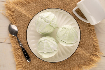 Sweet delicious pear marshmallow with ceramic saucer and cup on wooden table, macro, top view.