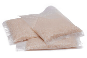 A Plastic Bags of White Long Grain Rice - Isolated on White Background. Small Transparent Packages with Dry Rice - Isolation