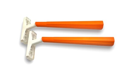 Top view of two disposable orange plastic razors, sleek and simple in design, ready for a clean shave with ergonomic handles for easy grip and use, isolated on white background.