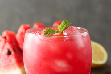 Tasty watermelon drink in glass on blurred background, closeup