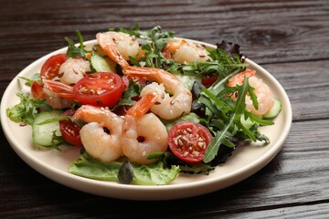 Delicious shrimp salad with vegetables on wooden table, closeup