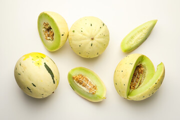 Fresh ripe honeydew melons on white background, flat lay