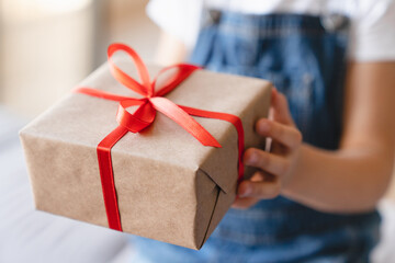 Giving receiving presents concept. Small kid child receiving giving gift box present with red...