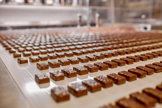 Candy production at a candy factory. Sweets on the conveyor belt. Industrial production, factory