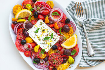 Greek salad with feta cheese and herbs. Greek bowl. Mediterranean cuisine and Greece. Healthy eating and recipes