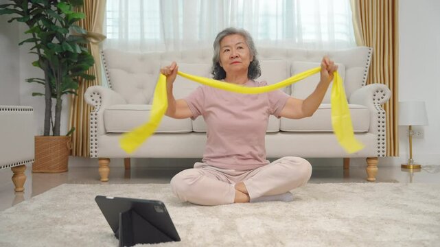 elderly people to exercise with elastic bands to increase muscle in the home, health care concept
