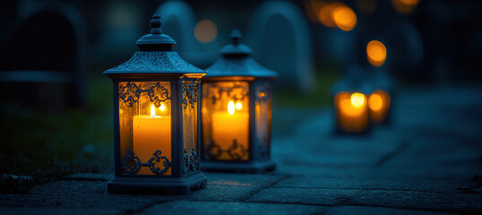 Lanterns with Burning Candles on the Cemetery Ground