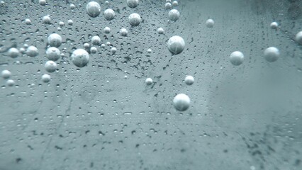 Macrography, witness the mesmerizing allure of a margarita bubble delicately adorned with a slice of lime, set against a bold black background. Each close-up shot of cocktail with lime. Comestible.