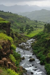 A river flows through a lush green valley with mountains in the background. The water is crystal clear and the surrounding vegetation is vibrant and healthy. Concept of tranquility and natural beauty