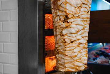 Juicy meat is fried on a shawarma spit.