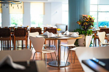 Setout table with tableware in restaurant.