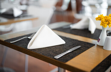 Setout table with tableware in modern restaurant.