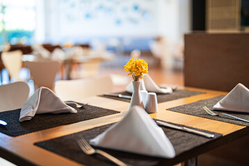 Setout table with tableware in modern restaurant.