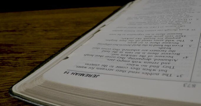 Holy Bible Macro Man Hand Turning Pages From Book Of Isaiah To Jeremiah
