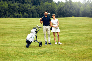 A Couple Enjoying a Beautiful Day on the Golf Course Together Amidst Lush Greenery