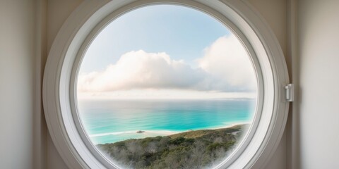 Fototapeta premium A Circular Window Reveals a Coastal Landscape Seen Through Clouds.