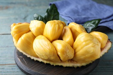 Fresh exotic jackfruit bulbs on light blue wooden table