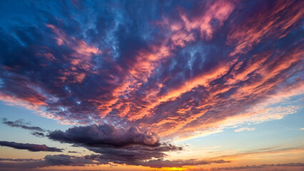Fototapeta premium Evening sky with white clouds glowing in warm sunset light. Sky shifts from deep blue to pink and orange near the horizon, with soft reflections adding depth, capturing a serene summer sunset.