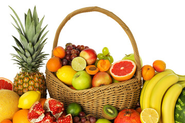 Many different fresh fruits in wicker basket isolated on white