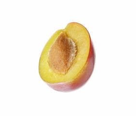 Half of ripe plum isolated on white