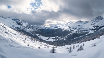 Panoramic view down snow covered valley in alpine mountain range