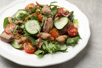 Delicious fresh tuna salad on grey table, closeup