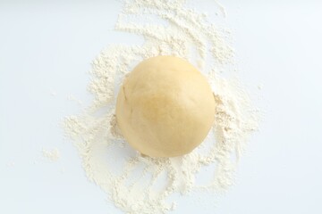 Cooking homemade pie. Raw dough and flour on white background, top view