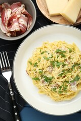 Delicious pasta Carbonara served on table, flat lay