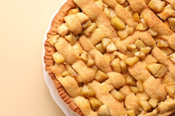 Tasty homemade apple pie on beige background, top view. Space for text