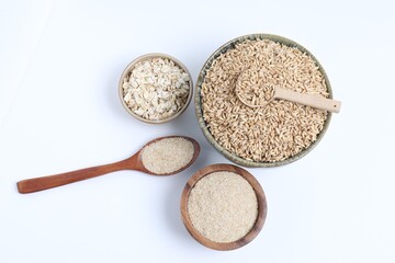 Oat grains, flakes and bran in bowls isolated on white, top view