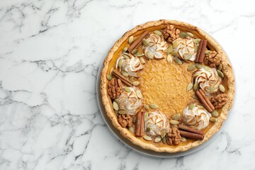 Tasty homemade pumpkin pie on white marble table, top view. Space for text