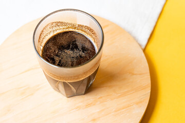 Glass of Black Coffee with Frothy Cream