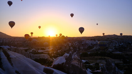 Colorful hot air balloons. Sunrise at Cappadocia. Bright colorful ballons flying during sunrise in valley. Goreme, Nevsehir, Cappadocia