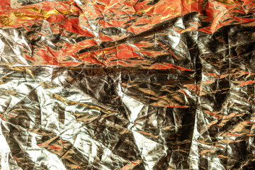 Crumpled Metallic Foil Texture with Red and Gold Hues