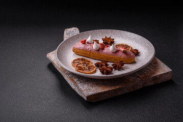 Sweet eclair or profiterole with strawberry custard