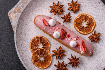 Sweet eclair or profiterole with strawberry custard