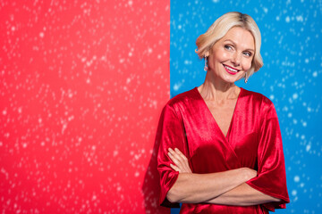 Fototapeta premium Photo of gorgeous dreamy lady dressed shiny red clothes arms folded looking empty space isolated blue color background