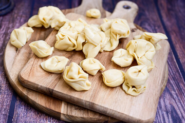 Raw fresh tortelloni pasta c Ring-shaped pasta  filled with   spinach and ricotta cheese.   Ready for cooking. Italian food concept.