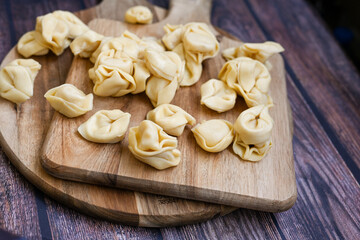 Raw fresh tortelloni pasta c Ring-shaped pasta  filled with   spinach and ricotta cheese.   Ready for cooking. Italian food concept.