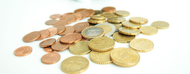 Pile of shiny coins on white background
