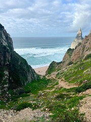 Atlantic ocean coast in Portugal. Scenic view of coastline with huge boulders at the Praia da Ursa beach near Cabo da Roca (Cape Roca). The westernmost point of mainland Europe.