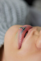 Obraz premium smile or frenulum piercing under the upper lip.