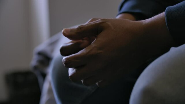 Nervous black man worried wringing hands