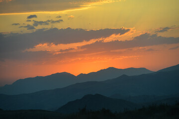 Beautiful sunset over the mountains in the summer.