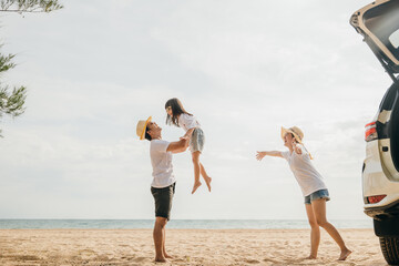 Happy family three playing on beach, Parents father holding child on his shoulders jump a child fly to air, holiday vacations summer road trip, back car, Family day enjoying their time together